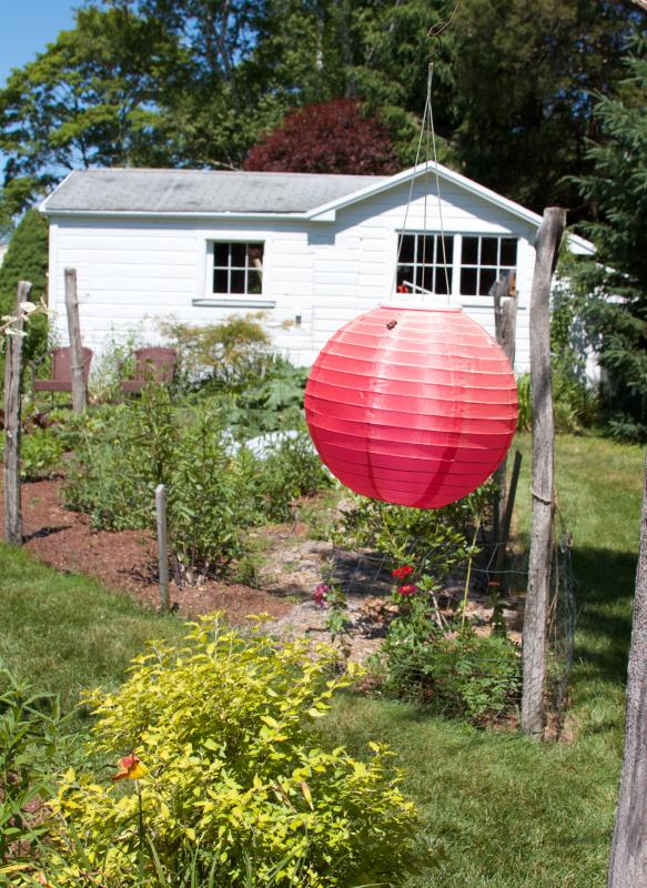 Jim Nordquist's triangular garden plots featured colorful flowers, vegetables and lanterns. BY GEORGIA SPARLING
